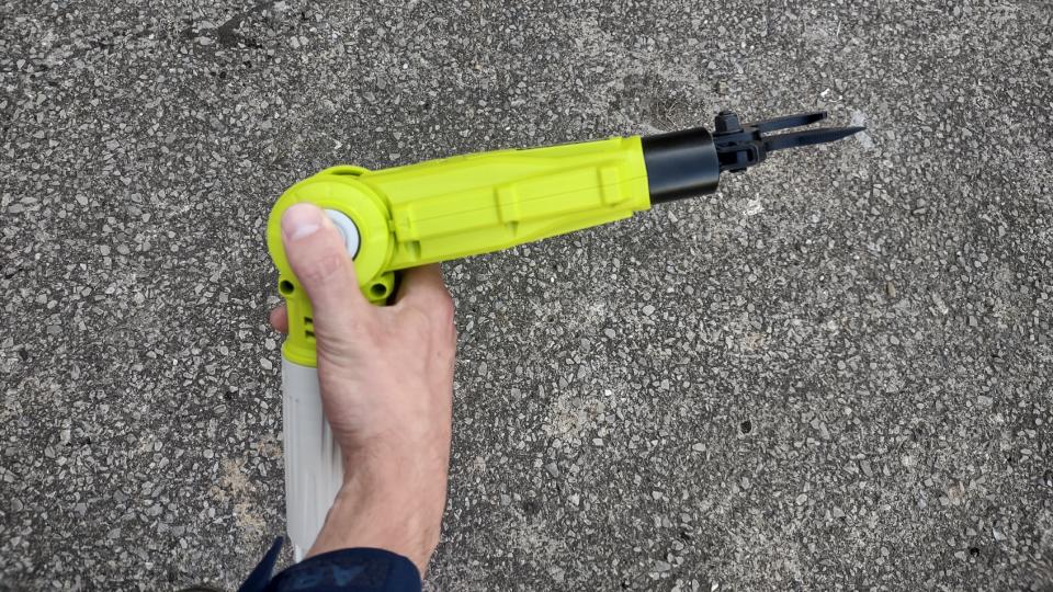 Writer, Pete Wise, adjusting the cutting head of the Ryobi ONE+ 18V Cordless Pole Lopper.