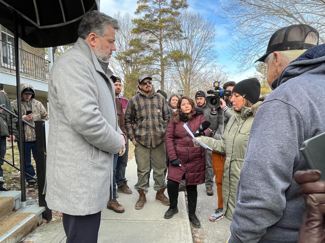 Kanien'kehá:ka Nation at Kahnawà:ke member Karihwakatste Deer reads a letter to Châteauguay Mayor Éric Allard, saying his municipality 'deliberately attempted to hide evidence' of an oil spill that seeped into her community. (Paula Dayan Perez/CBC - image credit)