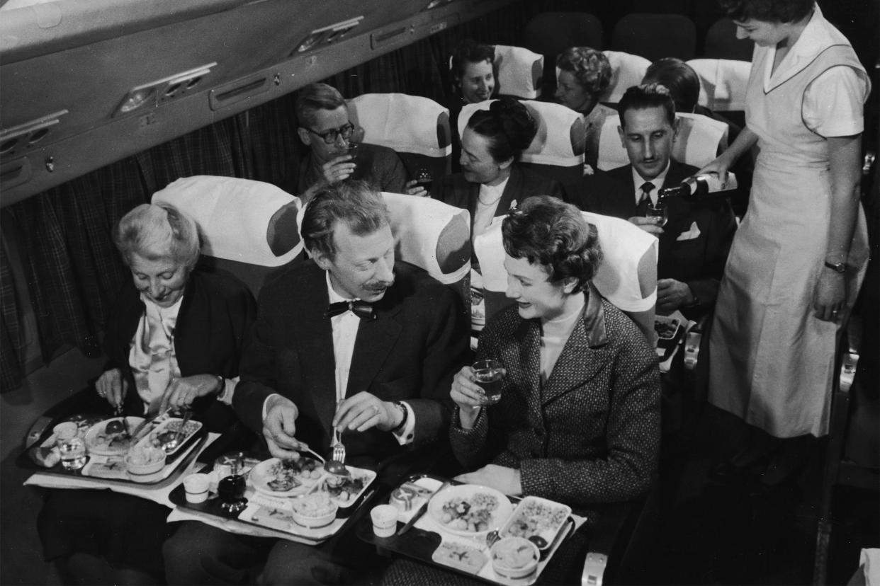 Well-dressed couples on a plane