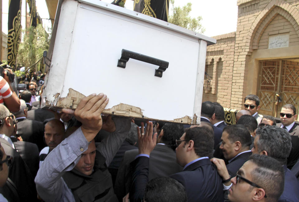 FILE - In this June 30, 2015 file photo, pall bearers carry the body of slain Egyptian Prosecutor General Hisham Barakat who was killed in bomb attack a day earlier, during his burial at a cemetery in Cairo. On Wednesday, Feb. 20, 2019 Egypt executed nine suspected Muslim Brotherhood members convicted of involvement in the 2015 assassination of Barakat, security officials said. The bombing that killed Barakat was the first assassination of a senior official in Egypt in a quarter century. (AP Photo/Ahmed Gamil, File)