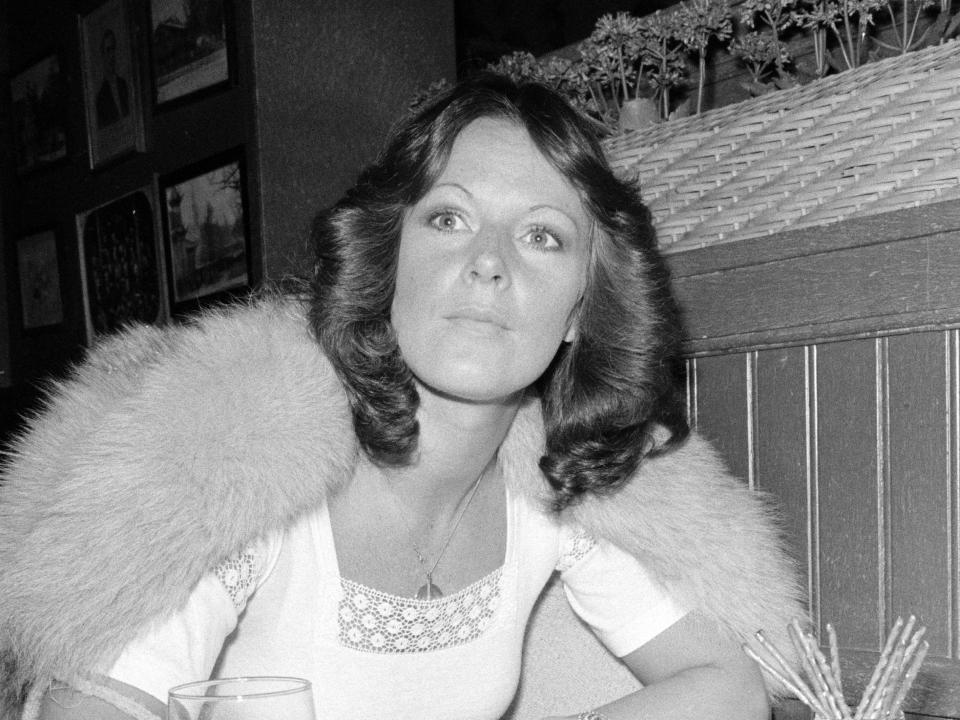 Anni-Frid Lyngstad of ABBA sits at a restaurant.
