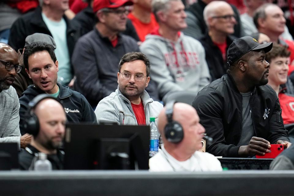 Mar 26, 2024; Columbus, OH, USA; From right, THE Foundation founders Cardale Jones and Brian Schottenstein watch the NIT quarterfinals between the Ohio State Buckeyes and the Georgia Bulldogs at Value City Arena.