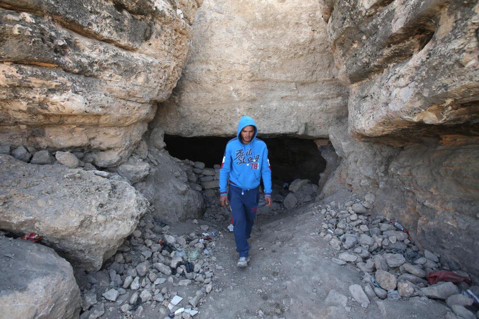 A Lebanese man steps outside a cave after he showed journalists where people hide from the shelling of Syrian government forces, in Tfail village, at the Lebanese-Syrian border, eastern Lebanon, Tuesday, April 22, 2014 A Lebanese convoy of soldiers, clerics and Red Cross officials delivered aid Tuesday to a remote village near the Syrian border that was bombed by Syrian government aircraft and blocked by Lebanese militants fighting alongside President Bashar Assad’s forces in the civil war next door. Hezbollah fighters have been patrolling the area on the Lebanese side and fighting has flared up inside Syria, cutting Tfail’s residents off from all sides for months. (AP Photo/Hussein Malla)