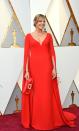 <p>Allison Janney wears a gorgeous red gown with a dramatic sleeve paired with a red clutch.</p>