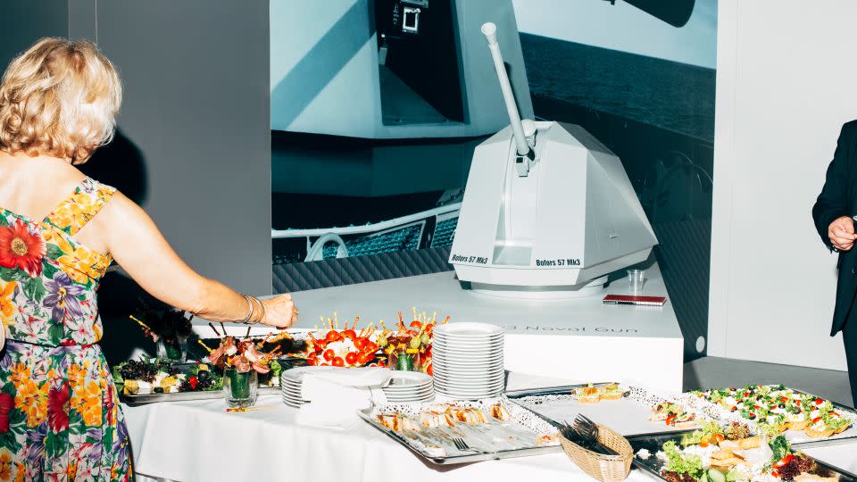 A model of a Swedish Bofors naval gun is the backdrop to a colorful buffet at the MSPO fair in Kielce, Poland in 2016. - Nikita Teryoshin