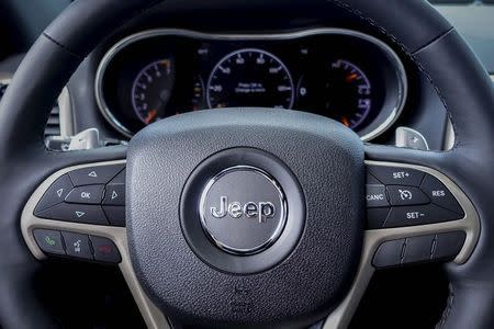 The logo of Jeep is seen on a steering wheel of the 2015 Jeep Grand Cherokee on a car dealership in New Jersey, in this July 24, 2015 file photo. REUTERS/Eduardo Munoz/Files