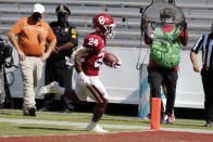 Oklahoma running back Marcus Major (24) scores a rushing touchdown against Texas during an NCAA college football game in Dallas, Saturday, Oct. 10, 2020. (AP Photo/Michael Ainsworth)