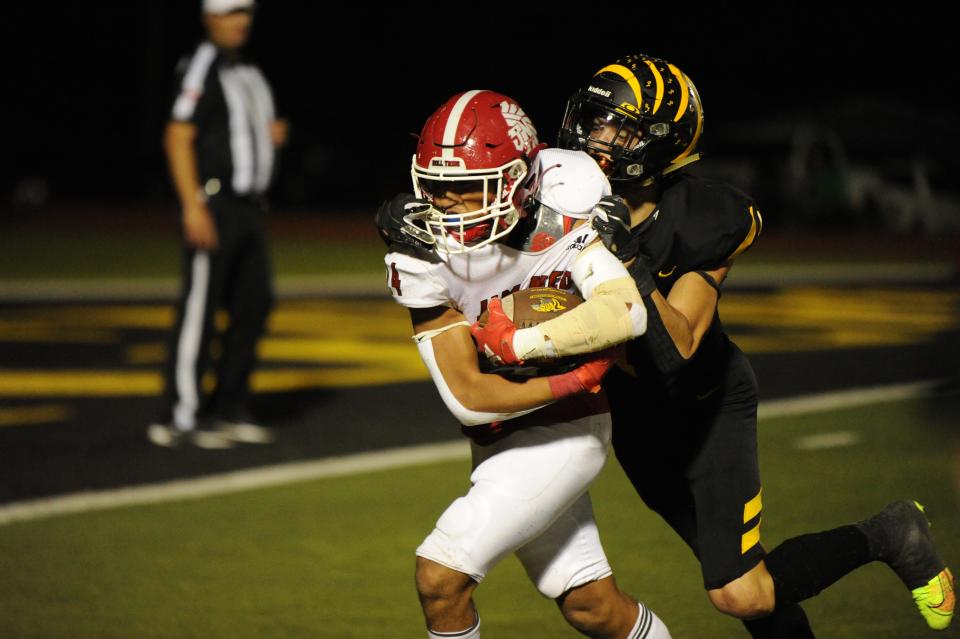 Jim Ned's Sergio Hernandez breaks a tackle before scoring a touchdown on a pick six against Cisco. The Loboes take on Haskell in a first-round game at Clyde.