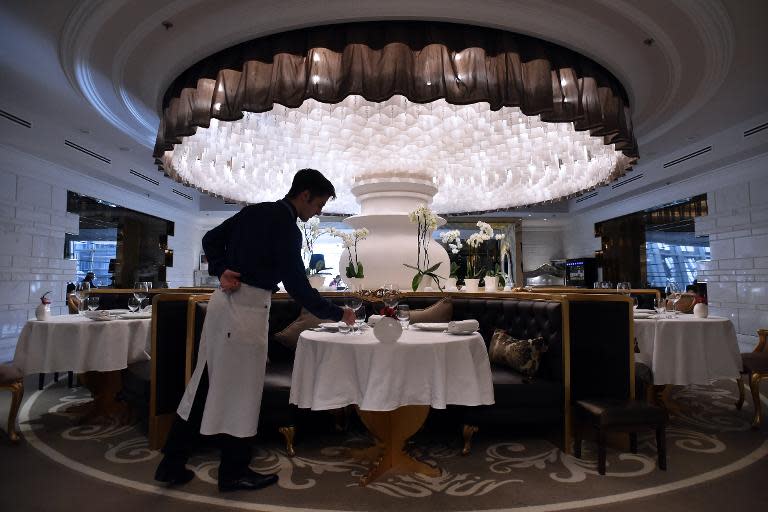 A member of staff lays a table in Les Menus restaurant in Moscow on March 23, 2015
