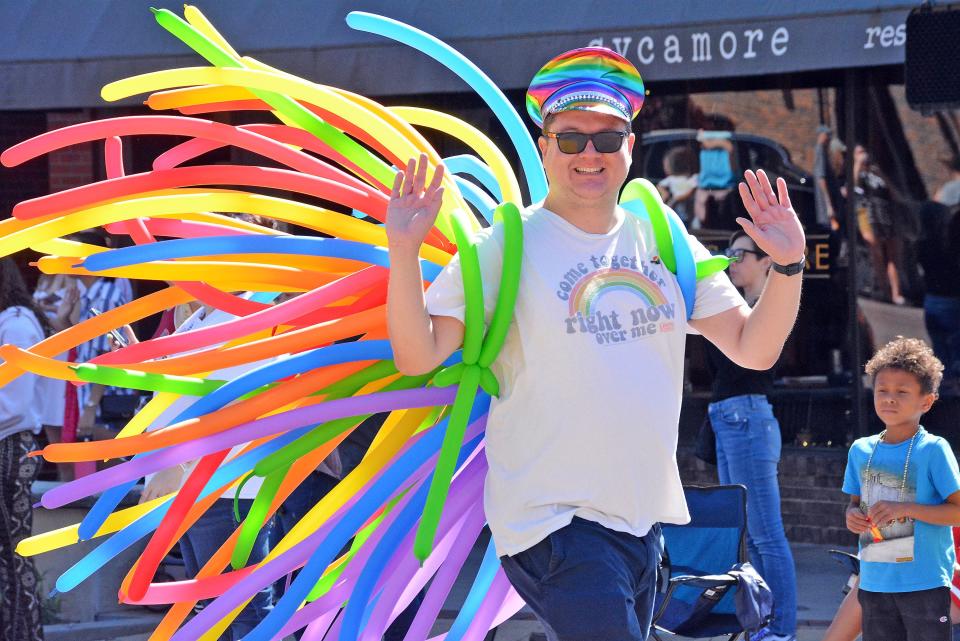 Patrons and employees of Columbia LGBTQ bar Arch and Column donned colorful balloon harnesses Sunday as part of the inaugural Mid-MO PrideFest parade in downtown Columbia. 