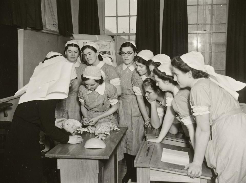 Student nurses gathered around a sister tutor explaining the anatomy of the human head, at the Preliminary Training School at York County Hospital, Monkgate, York