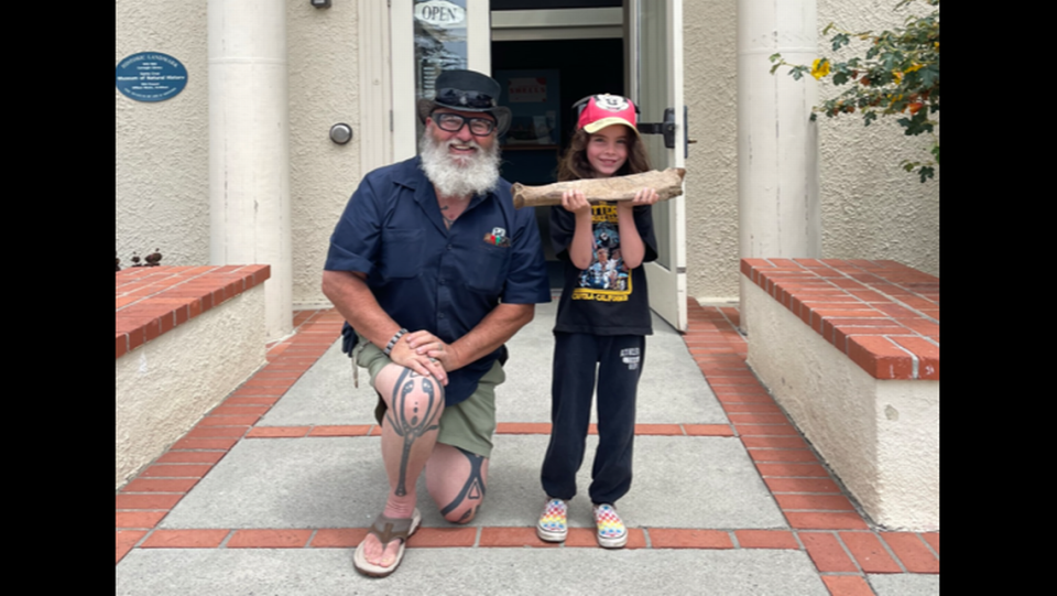 Wayne Thompson, a paleontologist with the museum, poses for a photo with one of the students who discovered the ancient floth fossil. Photo from Santa Cruz Museum of Natural History