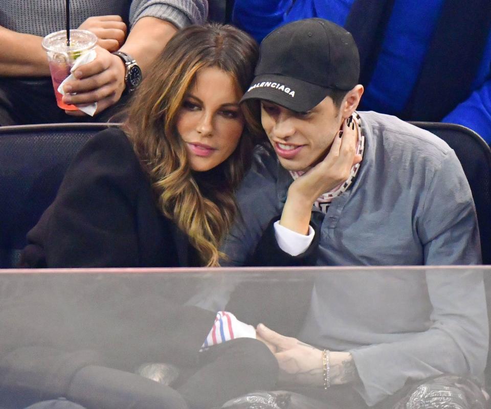 Kate Beckinsale and Pete cuddling at a game