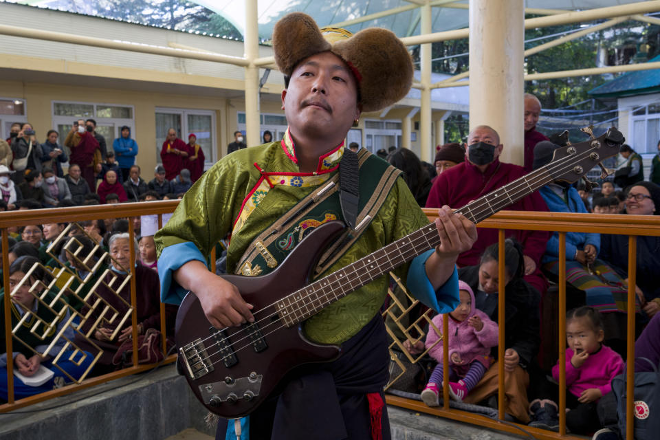 An exile Tibetan artist plays the guitar during an event marking the anniversary of the awarding of the Nobel Peace Prize to the Dalai Lama in Dharamshala, India, Sunday, Dec. 10, 2023. (AP Photo/Ashwini Bhatia)