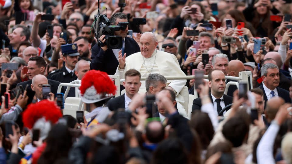 Pope Francis waves at onlookers from St. Peter's Square. - Yara Nardi/Reuters