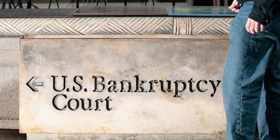 A man walks in front of a United States Bankruptcy Court sign in New York City.