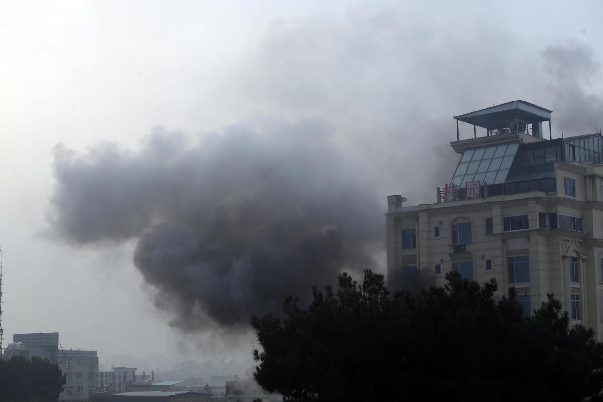Smoke rises from a hotel building after an explosion and gunfire in the city of Kabul, Afghanistan, Dec. 12, 2022. / Credit: AP