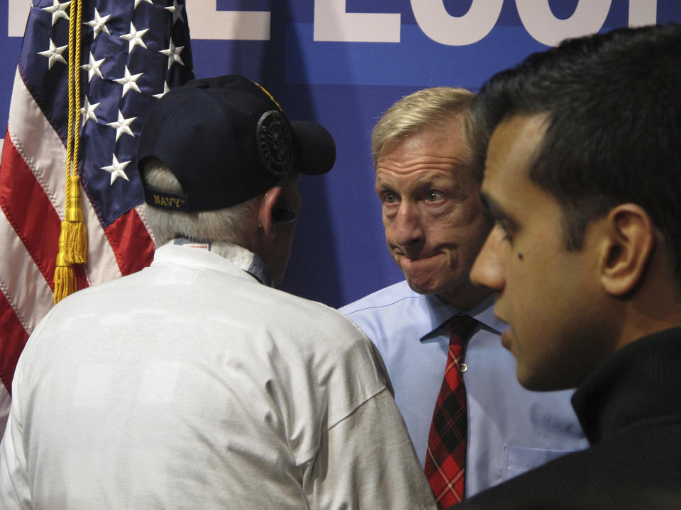 In this Tuesday, Feb. 11, 2020, photo, Democratic presidential hopeful Tom Steyer listens to a U.S. military veteran after speaking to about 200 people during a town hall gathering at the National Automobile Museum in Reno, Nev. The California billionaire says his campaign is "doing fine" despite dismal showings in Iowa and New Hampshire, but has to do "very well" in the Nevada caucuses next up Feb. 22. (AP Photo/Scott Sonner)