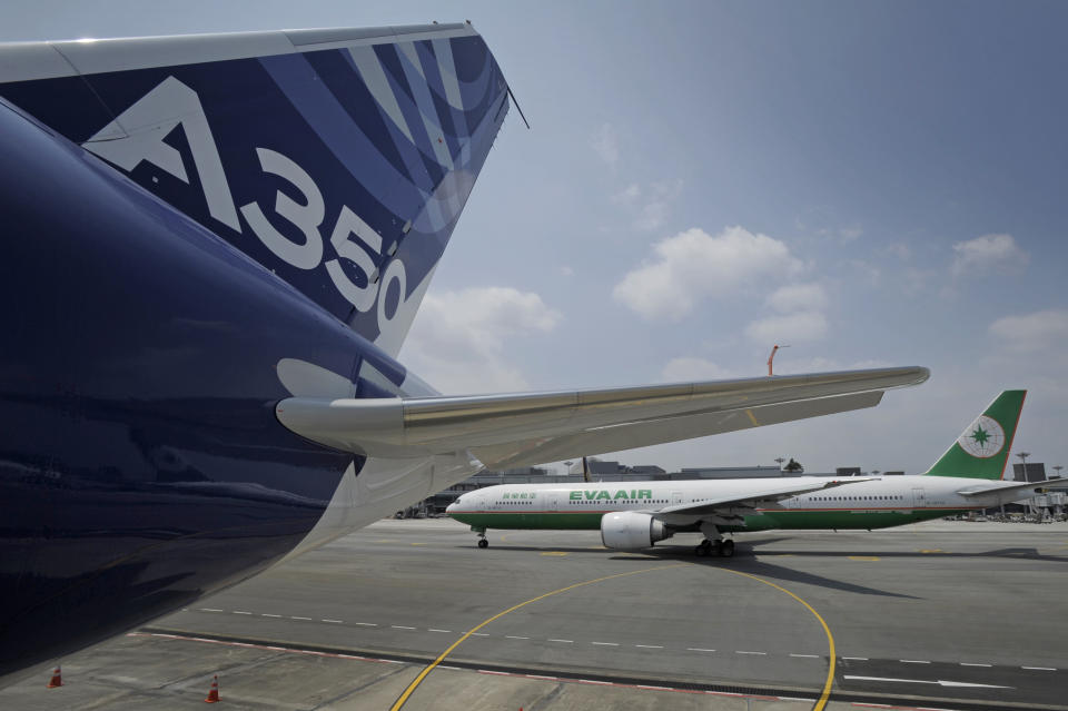 An Airbus A350-900 test plane is seen at Singapore's Changi Airport at a media preview ahead of the upcoming Singapore Air Show on Monday, Feb. 10, 2014. Airbus is showing off its new wide-body A350 at Asia's biggest airshow this week. It's a strong sign the European plane maker is on schedule to start delivering the advanced jet to airline customers in the second half of the year. (AP Photo/Joseph Nair)