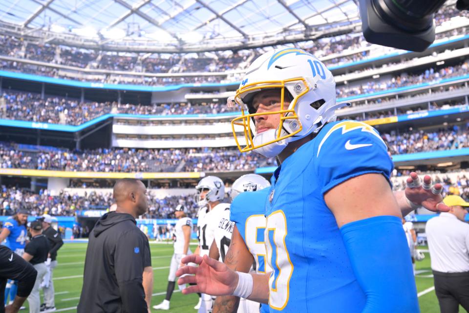 Los Angeles Chargers quarterback Justin Herbert walks off the field after a game against the Las Vegas Raiders. He fractured his finger during the game.