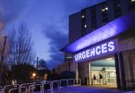 Members of the staff are seen outside the emergency services at the CHU Nord hospital in Grenoble, French Alps, where retired seven-times Formula One world champion Michael Schumacher is hospitalized after a ski accident, December 30, 2013. Former Formula One champion Michael Schumacher was battling for his life in hospital on Monday after a ski injury, doctors said, adding it was too early to say whether he would pull through. Schumacher was admitted to hospital on Sunday suffering head injuries in an off-piste skiing accident in the French Alps resort of Meribel. (REUTERS/Robert Pratta)