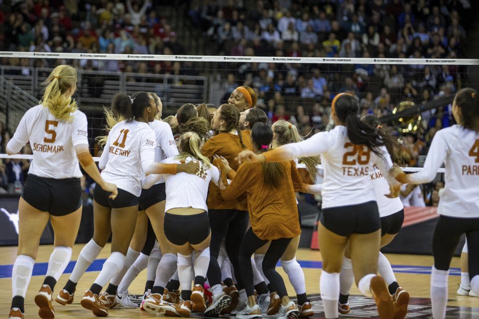 Texas Longhorns players celebrate their win over San Diego in four sets in the semifinals of the NCAA women's volleyball tournament, Thursday, Dec. 15, 2022, in Omaha, Neb.