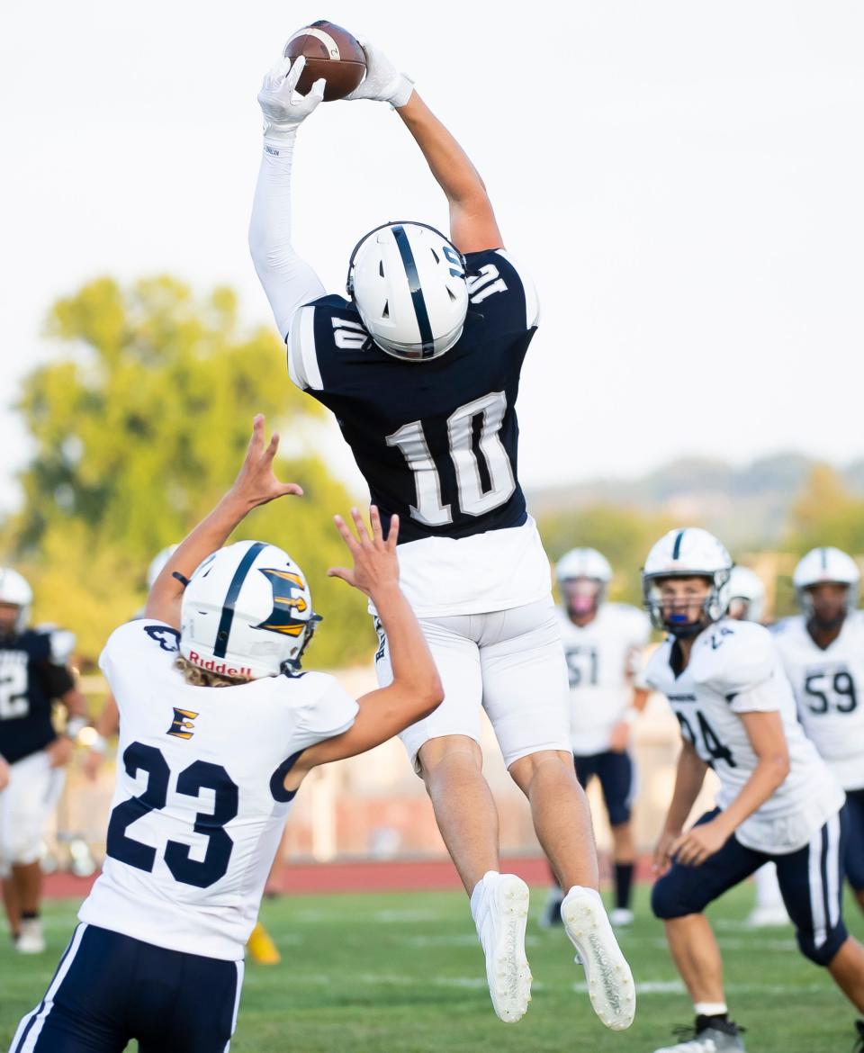 West York wide receiver Kyan Moore (10) leaps in the air to pull down a catch during a non-conference football game against ELCO at West York Area High School Friday, August 25, 2023.