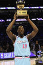 Miami Heat's Bam Adebayo holds the trophy after winning NBA basketball's All-Star skills challenge Saturday, Feb. 15, 2020, in Chicago. (AP Photo/David Banks)