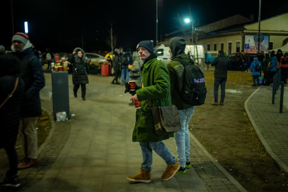 A man is seen, pivoting to face the camera, on a city street.