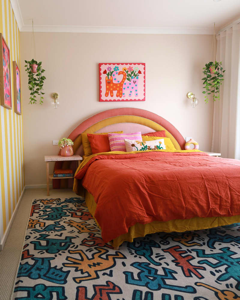 Rainbow headboard in colorful bedroom during renovation.