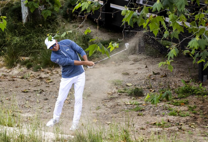 Co-leader Ricky Fowler hits out of the sandy rough on the 9th hole during the first round of the U.S. Open.