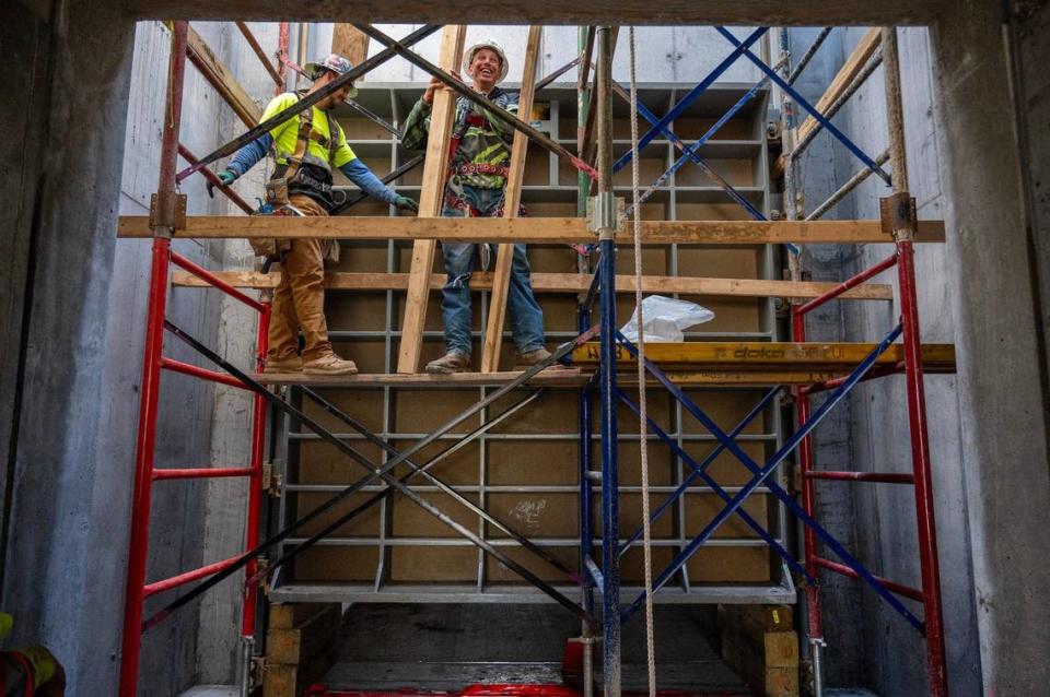 Construction workers install a sluice gate to control water flow at the Santa Fe Ditch construction site for the Kansas Citys Levee Project. Emily Curiel/ecuriel@kcstar.com