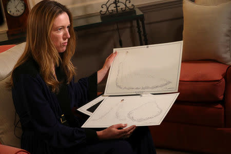 Clare Waight Keller, designer at Givenchy, holds sketches as she gives an interview the day after Meghan Markle walked down the aisle of St George's Chapel in Windsor and married Prince Harry wearing the dress that she created, in Kensington Palace, London, Britain, May 20, 2018. REUTERS/Hannah McKay/Pool