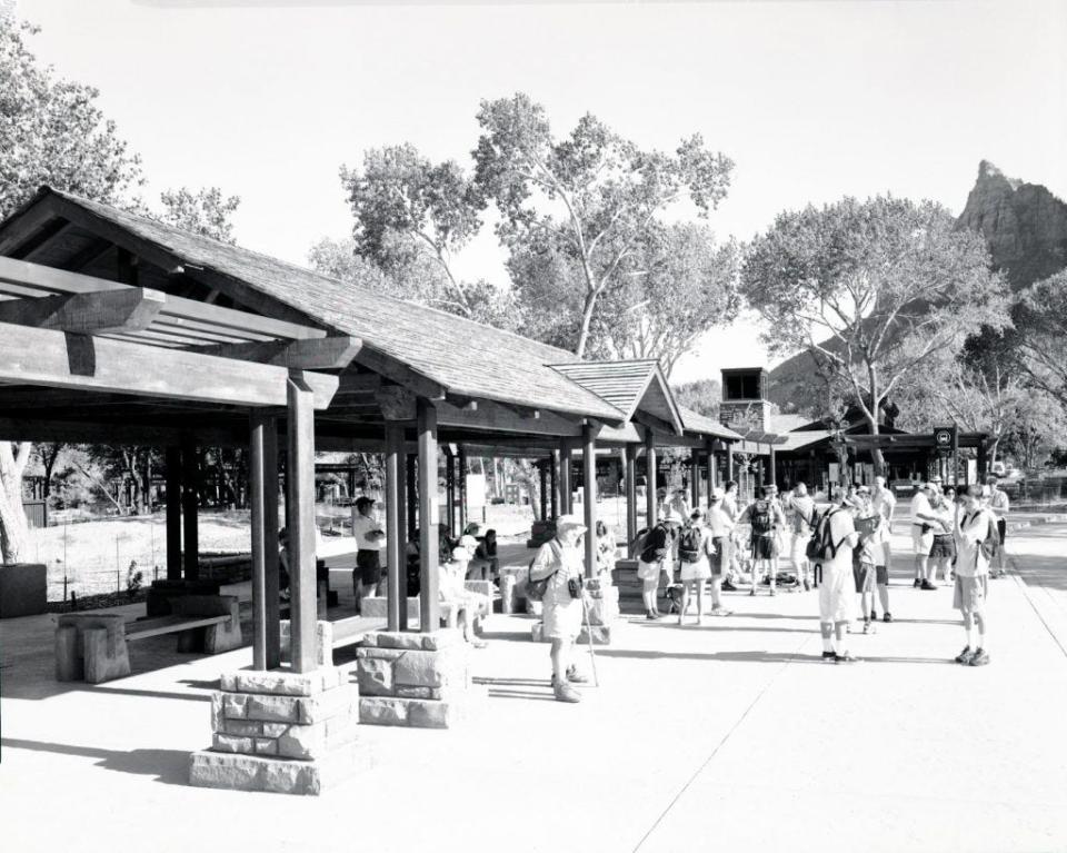 Visitors on June 6, 2000 wait at the Zion National Park Visitor Center for the newly minted shuttle.