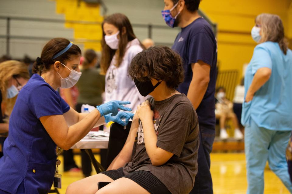 Raegan Mercer, a 12-year-old Landon Middle School student, receives a COVID-19 vaccine during a vaccine clinic at Topeka High School in 2021.