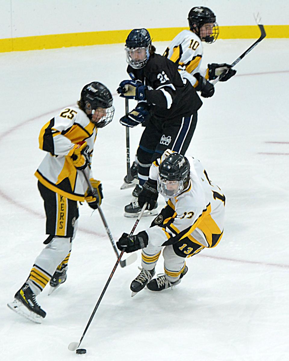 Tommy Foley of the Watertown Lakers controls the puck in front of teammate Hudson Hendricks during their SDAHA varsity boys hockey game on Friday, Feb. 23, 2024 in the new Prairie Lakes Ice Arena's Premier Rink in Watertown. Looking on are Watertown's Mylan Evans and Mitchell's Tyson Sabers. Mitchell won 5-2.