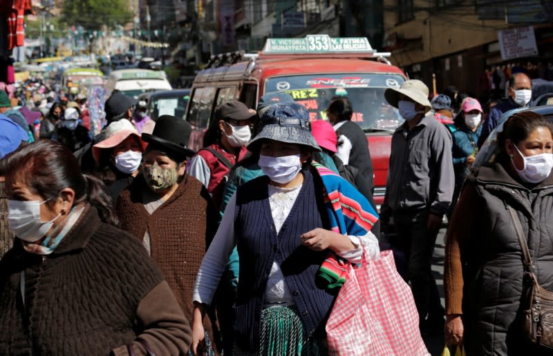 People wearing face masks are seen on the first day of eased coronavirus disease (COVID-19) restrictions in La Paz