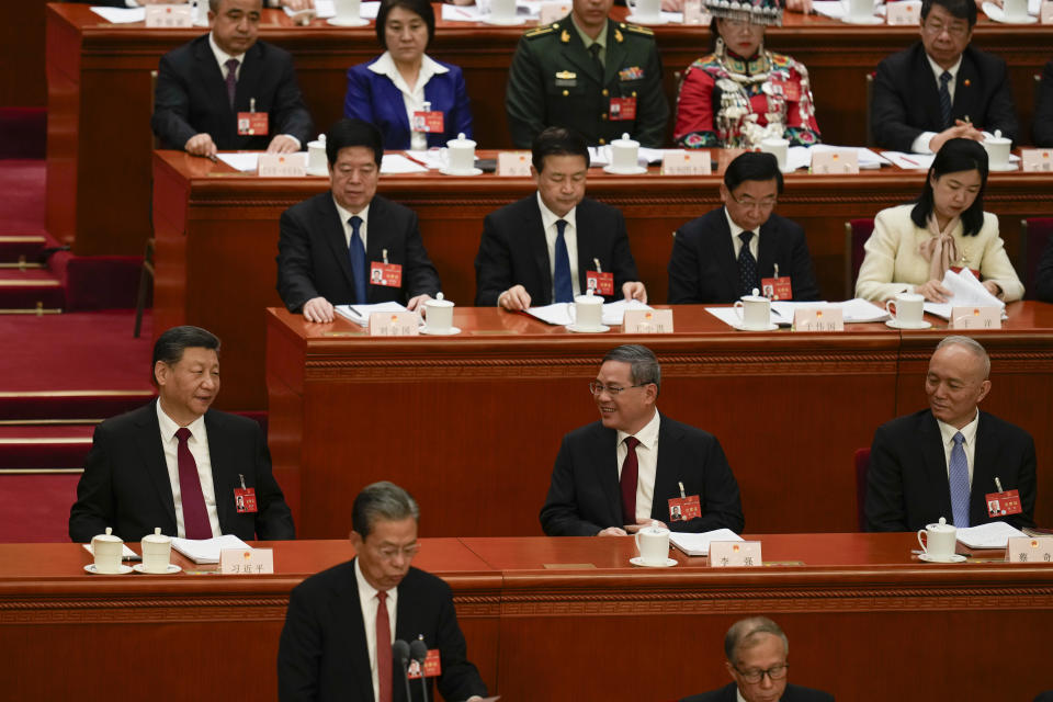 Chinese President Xi Jinping, left, together with Chinese Premier Li Qiang attend the opening session of the National People's Congress (NPC) at the Great Hall of the People in Beijing, China, Tuesday, March 5, 2024. (AP Photo/Ng Han Guan)