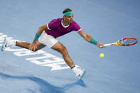 Rafael Nadal of Spain plays a forehand return to Karen Khachanov of Russia during their third round match at the Australian Open tennis championships in Melbourne, Australia, Friday, Jan. 21, 2022. (AP Photo/Hamish Blair)