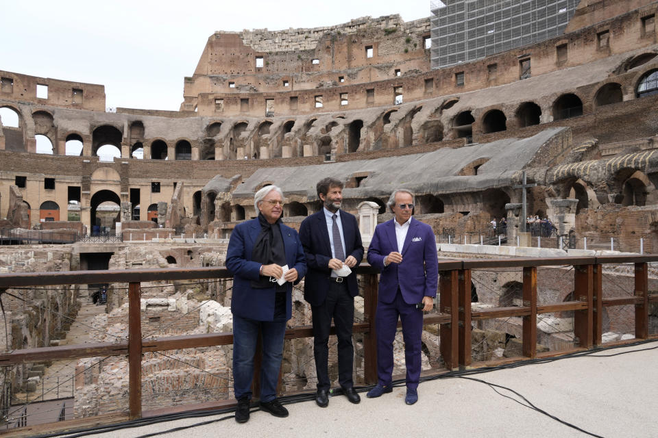 From left, Tod's Diego Della Valle, Italian Culture Minister Dario Franceschini and Tod' Andrea Della Valle pose for the media prior to the start of a press conference at the Colosseum, in Rome, Friday, June 25, 2021. Italy’s culture minister on Friday formally announced the completion of work to shore-up and restore the underground section, in the presence of the founder of Tod’s, the shoe-and-luxury-goods maker, who has footed the bill. AP Photo/Andrew Medichini)