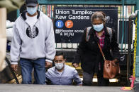 People wearing protective masks during the coronavirus pandemic exit the Kew Gardens subway station Monday, Oct. 5, 2020, in the Kew Gardens neighborhood of the Queens borough of New York. New York Gov. Andrew Cuomo on Monday ordered schools in certain New York City neighborhoods closed within a day in an attempt to halt flare-ups of the coronavirus. (AP Photo/Frank Franklin II)