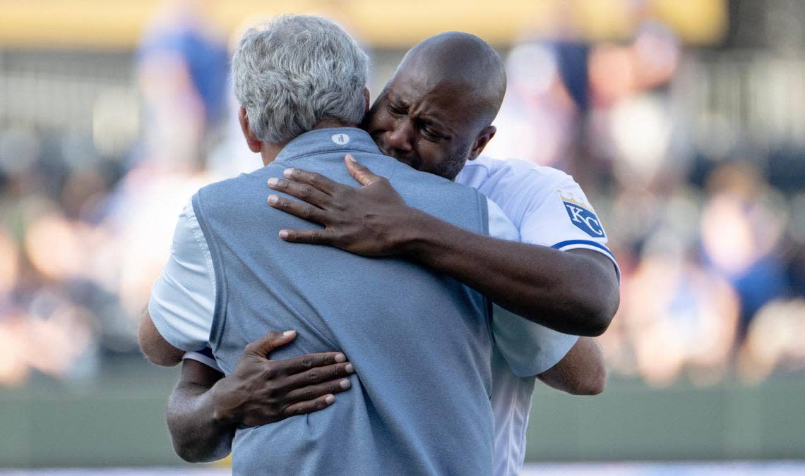 Former Kansas City Royals center fielder Lorenzo Cain hugs former first base coach Rusty Kuntz during a retirement ceremony at Kauffman Stadium on Saturday, May 6, 2023, in Kansas City. Cain signed a ceremonial one-day contract to retire as a Royal.