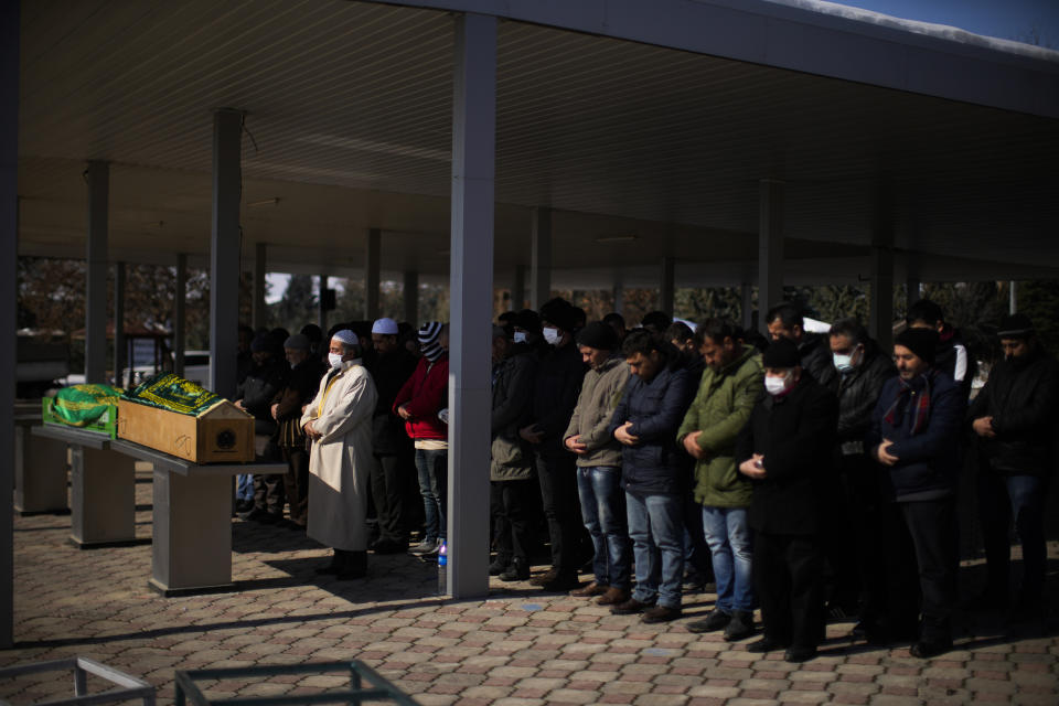 Men pray during the funeral of two people killed during the earthquake at Sehir cemetery in Malatya, Turkey, Sunday, Feb. 12, 2023. Five days after two powerful earthquakes hours apart caused scores of buildings to collapse, killing thousands of people and leaving millions homeless, rescuers were still pulling unlikely survivors from the ruins. (AP Photo/Francisco Seco)