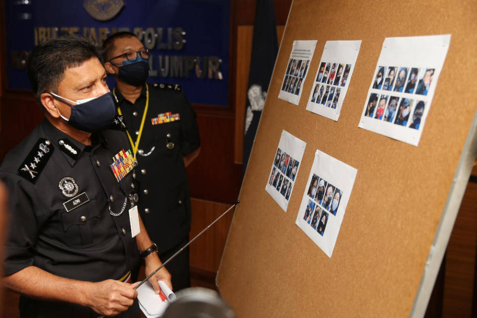 Kuala Lumpur police chief Datuk Azmi Abu Kassim showing pictures of participants of the #KeluarDanLawan demo at the Kuala Lumpur Contingent Police Headquarters, August 2, 2021. ― Picture by Choo Choy May