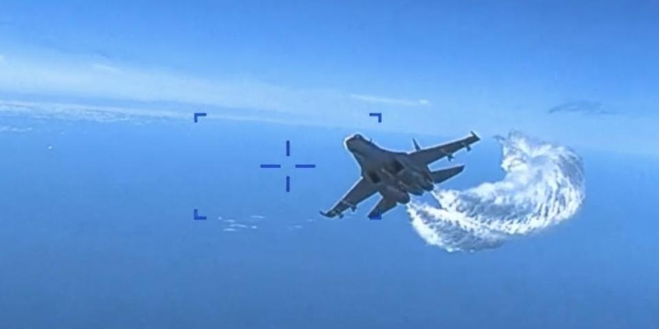 A Russian Su-27 fighter jet approaches a US military MQ-9 Reaper drone operating above the Black Sea on March 14, 2023.