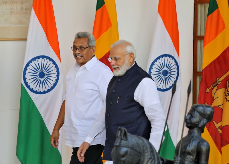 Sri Lanka's President Rajapaksa and India's PM Modi arrive for a photo opportunity ahead of their meeting at Hyderabad House in New Delhi