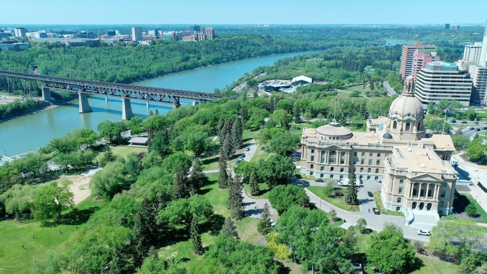 Aerial view of Alberta Legislature Building and Downtown Edmonton skyline on a sunny day. See High Level Bridge of Edmonton spanning North Saskatchewan River.