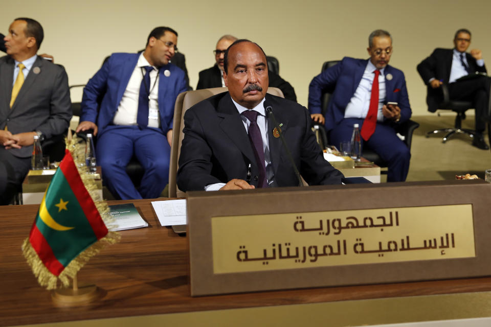 FILE - In this Jan. 20, 2019, file photo, Mauritania's President Mohamed Ould Abdel Aziz, center, attends the Arab Economic and Social Development Summit, in Beirut, Lebanon. Mauritanians are going to the polls on Saturday, June 22, 2019, as his preferred successor faces five opposition candidates in the West African nation threatened by Islamic extremism. (AP Photo/Bilal Hussein, File)