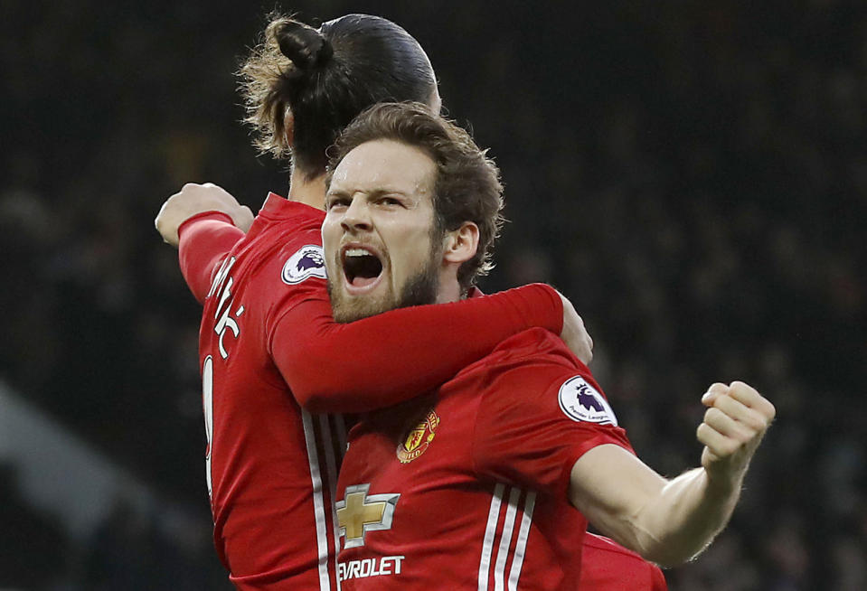 Manchester United's Daley Blind, right, celebrates scoring his side's first goal of the game against Sundeland with teammate Zlatan Ibrahimovic during the English Premier League soccer match at Old Trafford, Manchester England Monday Dec. 26, 2016. (Martin Rickett/PA via AP)