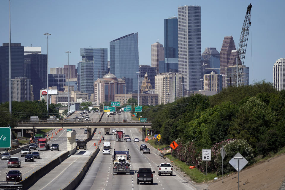 FILE - Traffic moves along Interstate 10 near downtown Houston, April 30, 2020. The Justice Department said Friday, July 22, 2022, that it is investigating illegal dumping in the city of Houston, including dead bodies, that officials said are left in Black and Latino neighborhoods in the nation’s fourth largest city. (AP Photo/David J. Phillip, File)